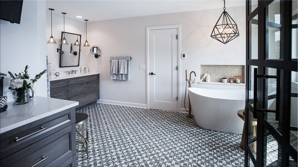 Design ideas for a mid-sized industrial master bathroom in Chicago with shaker cabinets, medium wood cabinets, a freestanding tub, a corner shower, a two-piece toilet, yellow tile, subway tile, grey walls, cement tiles, an undermount sink, engineered quartz benchtops, grey floor, a hinged shower door and white benchtops.