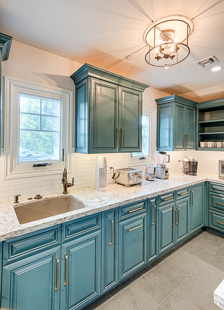 Inspiration for a large transitional u-shaped kitchen pantry in Los Angeles with an undermount sink, beaded inset cabinets, blue cabinets, quartzite benchtops, white splashback, subway tile splashback, stainless steel appliances, slate floors, no island, grey floor and white benchtop.