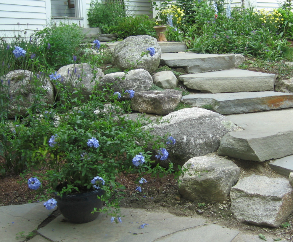 Photo of a mid-sized rustic hillside retaining wall landscape in Calgary.