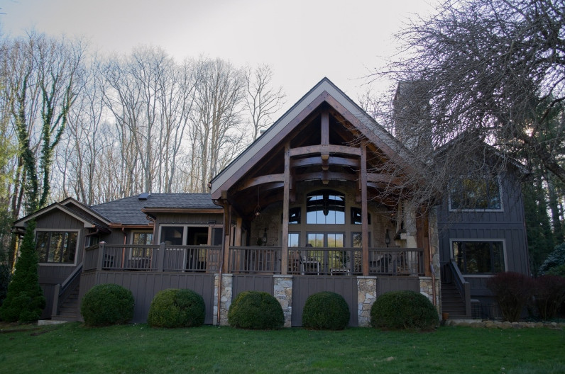 Mid-sized rustic green two-story wood gable roof idea with a shingle roof
