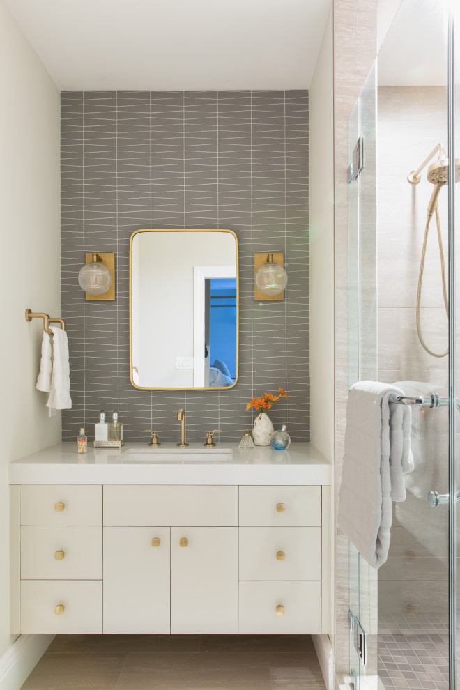 This is an example of a mid-sized transitional 3/4 bathroom in San Francisco with gray tile, glass tile, engineered quartz benchtops, flat-panel cabinets, beige cabinets, an alcove shower, an undermount sink, beige floor, a hinged shower door, beige benchtops, a single vanity and a floating vanity.