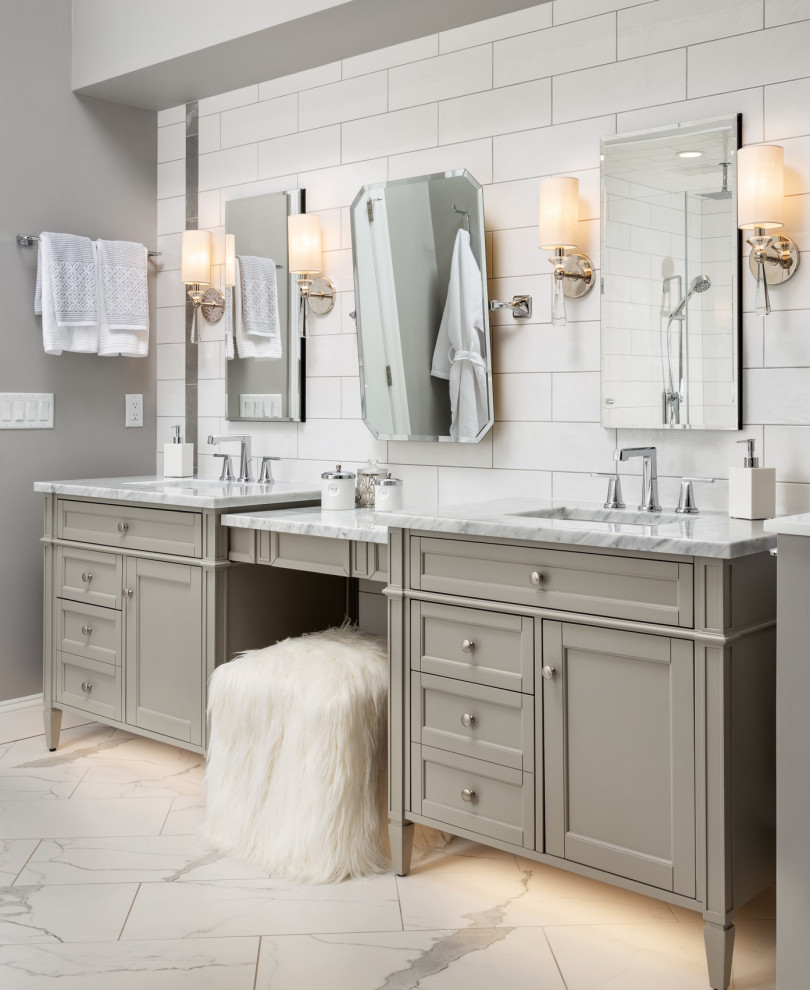 Design ideas for a large transitional master bathroom in New York with furniture-like cabinets, grey cabinets, a freestanding tub, an alcove shower, a one-piece toilet, white tile, subway tile, grey walls, porcelain floors, an undermount sink, marble benchtops, multi-coloured floor, a hinged shower door, white benchtops, a shower seat, a double vanity, a freestanding vanity and vaulted.