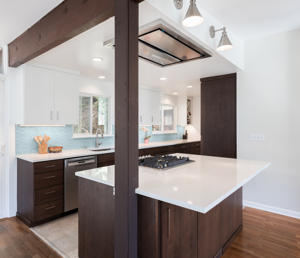 Photo of a mid-sized midcentury galley eat-in kitchen in Seattle with an undermount sink, flat-panel cabinets, dark wood cabinets, quartz benchtops, blue splashback, ceramic splashback, stainless steel appliances, vinyl floors, with island and white benchtop.