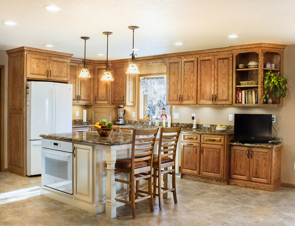 Mid-sized elegant l-shaped ceramic tile and beige floor kitchen photo with an undermount sink, raised-panel cabinets, medium tone wood cabinets, granite countertops, white appliances, an island and multicolored countertops