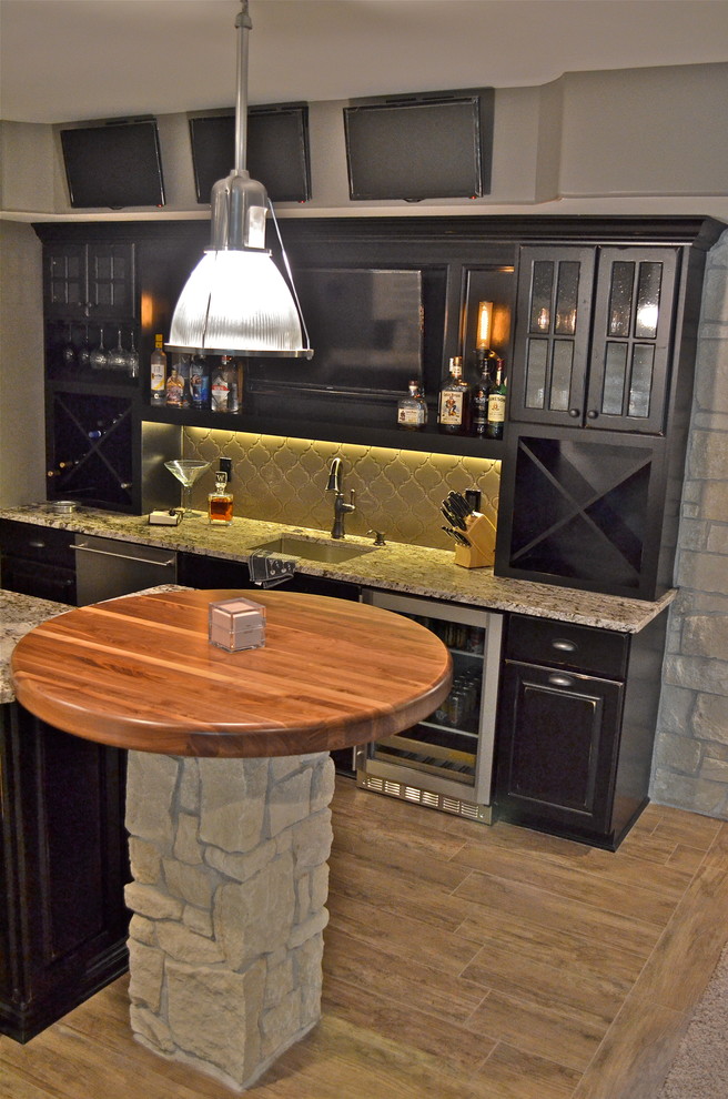 Example of a mountain style ceramic tile home design design in Omaha with an undermount sink, black cabinets, granite countertops and glass tile backsplash