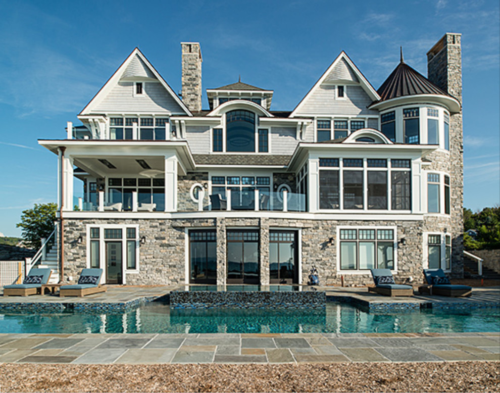Inspiration for a large transitional backyard stone and custom-shaped natural hot tub remodel