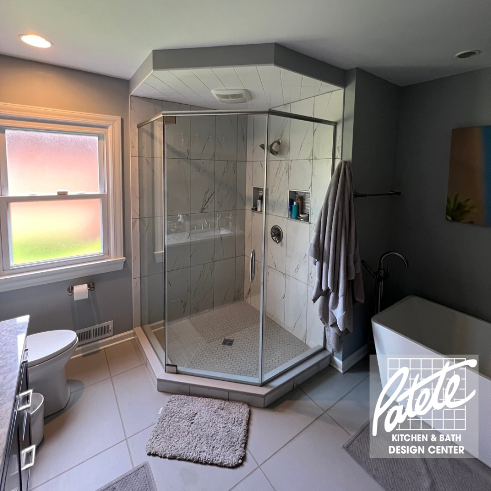Photo of a transitional bathroom in Other with a corner shower, black and white tile, marble, ceramic floors, grey floor and a hinged shower door.