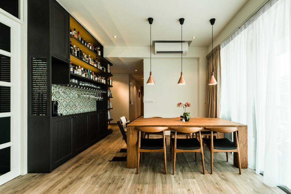 Transitional separate dining room in Singapore with beige walls, light hardwood floors and beige floor.