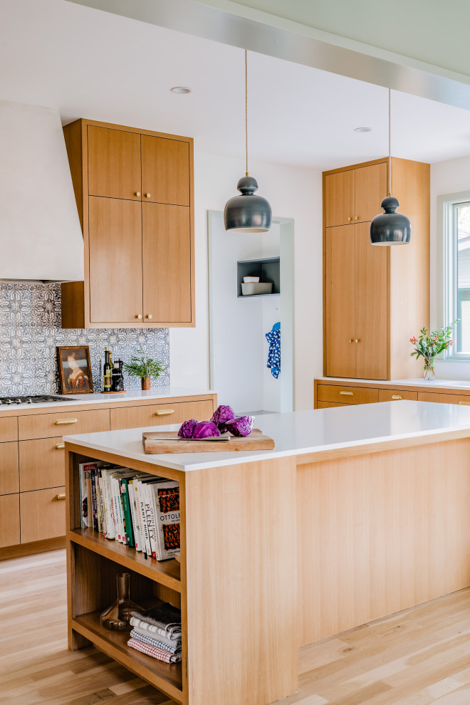 Example of a transitional light wood floor and beige floor kitchen design in Austin with multicolored backsplash, ceramic backsplash and stainless steel appliances