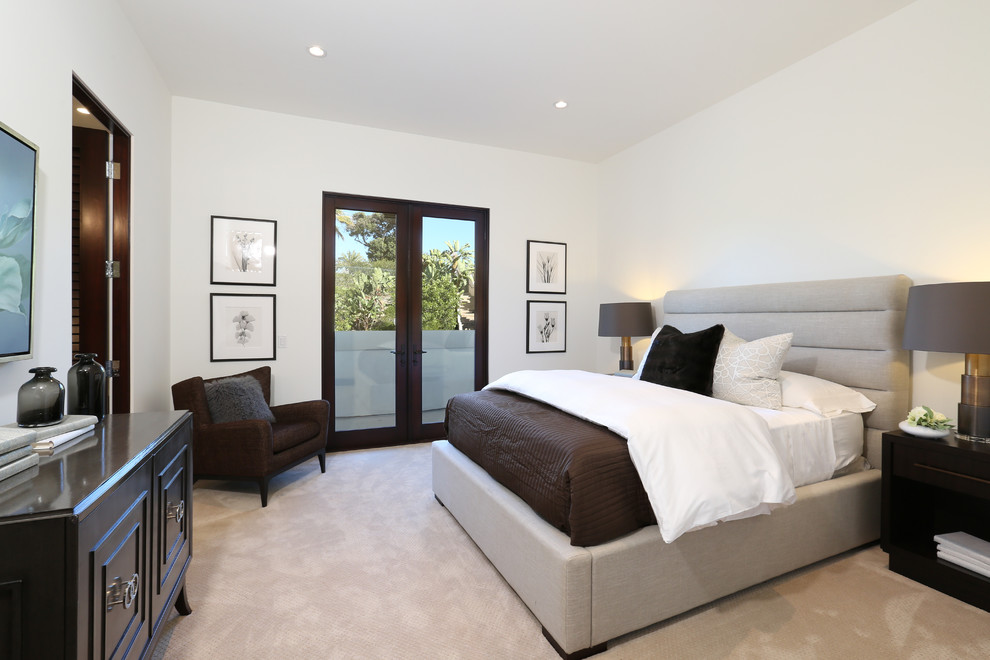 Large transitional guest bedroom in Orange County with white walls and carpet.