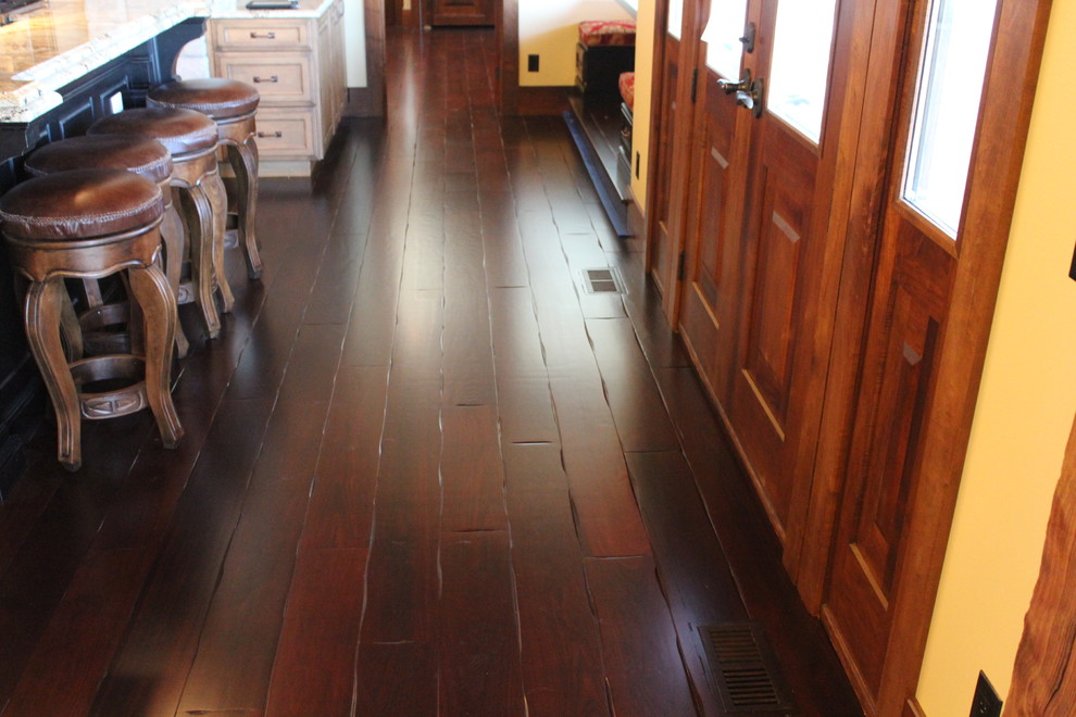 Large arts and crafts galley eat-in kitchen in St Louis with dark hardwood floors and multiple islands.