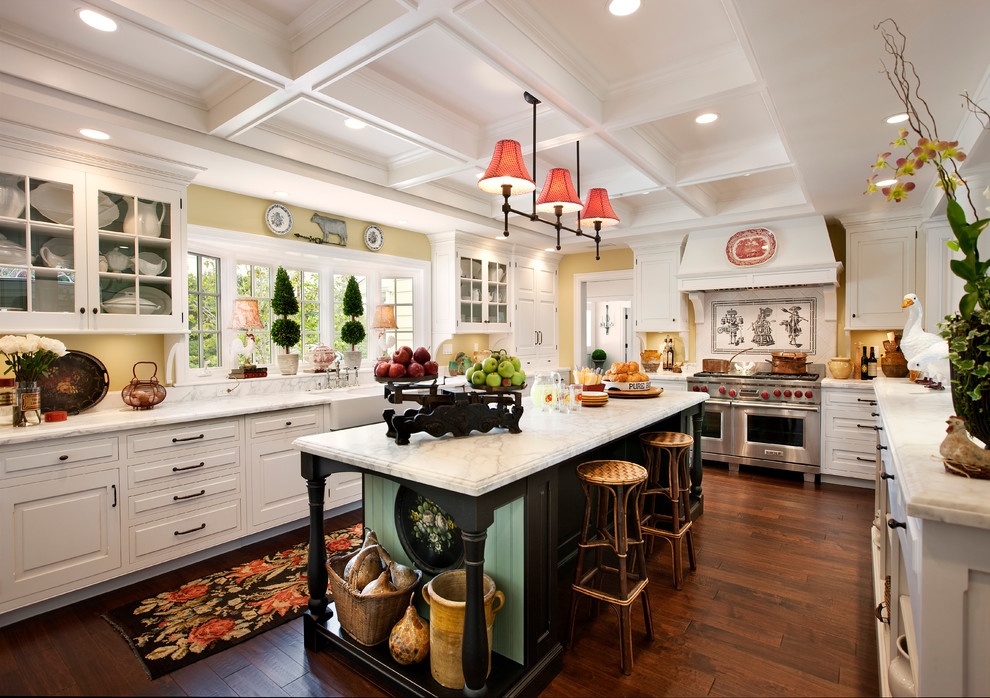 This is an example of a traditional u-shaped kitchen in Santa Barbara with raised-panel cabinets, white cabinets and stainless steel appliances.
