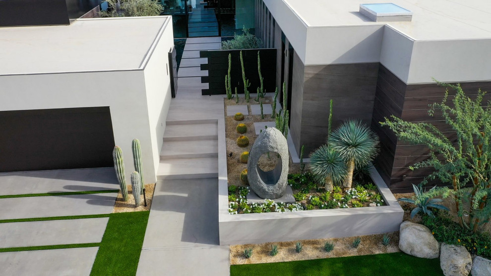 Modelo de jardín de secano minimalista de tamaño medio en patio delantero con paisajismo estilo desértico, exposición total al sol, gravilla y con madera