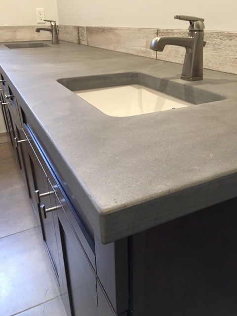 Inspiration for a mid-sized industrial u-shaped separate kitchen in Seattle with an undermount sink, shaker cabinets, grey cabinets, concrete benchtops, white splashback, ceramic splashback, stainless steel appliances, dark hardwood floors, with island and brown floor.