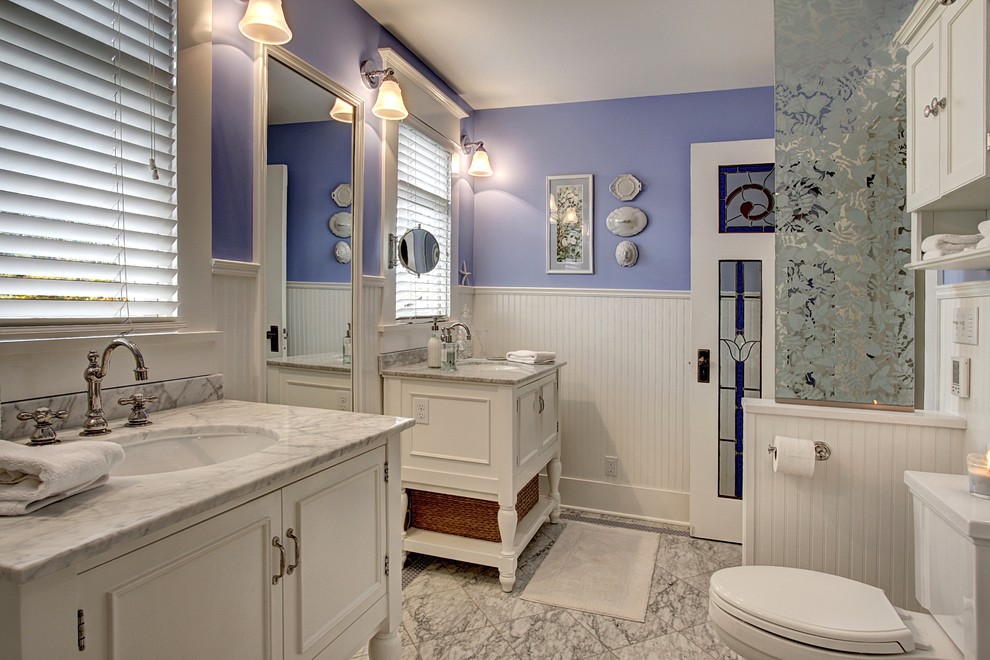 Example of a classic white tile and subway tile bathroom design in Seattle with an undermount sink, furniture-like cabinets, white cabinets, marble countertops and a two-piece toilet