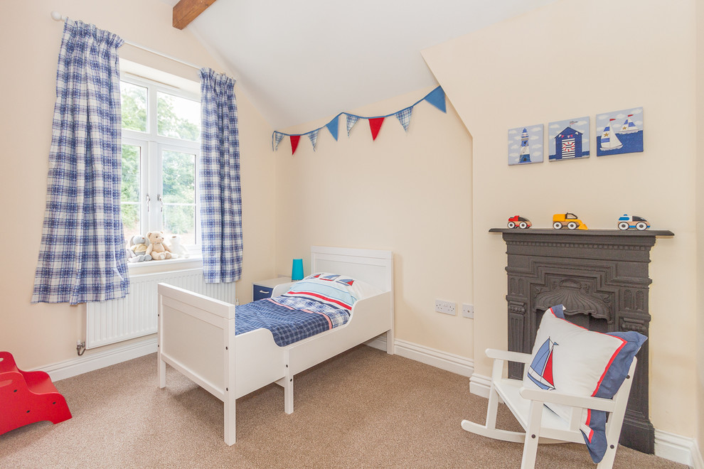 Photo of a small traditional kids' room in Other with beige walls and carpet.