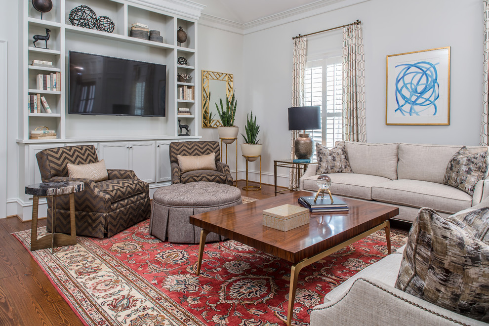 Traditional family room in Atlanta with white walls, dark hardwood floors, a wall-mounted tv and brown floor.