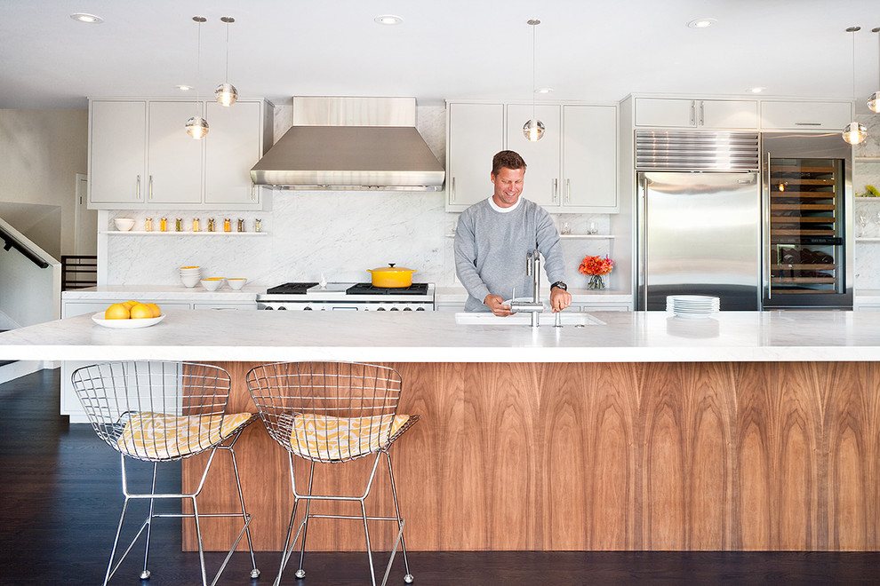 Midcentury galley kitchen in San Francisco with an undermount sink, flat-panel cabinets, white cabinets, white splashback, stainless steel appliances, marble benchtops and marble splashback.