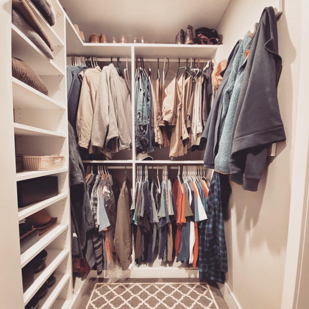 Design ideas for a modern gender-neutral walk-in wardrobe in Portland with flat-panel cabinets.
