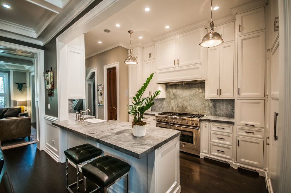 Inspiration for a mid-sized transitional u-shaped dark wood floor eat-in kitchen remodel in Chicago with a farmhouse sink, recessed-panel cabinets, white cabinets, quartzite countertops, stone slab backsplash, stainless steel appliances, a peninsula and gray backsplash