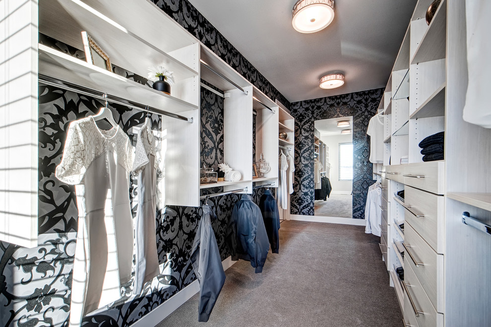 This is an example of a large contemporary gender-neutral walk-in wardrobe in Calgary with flat-panel cabinets, white cabinets and carpet.
