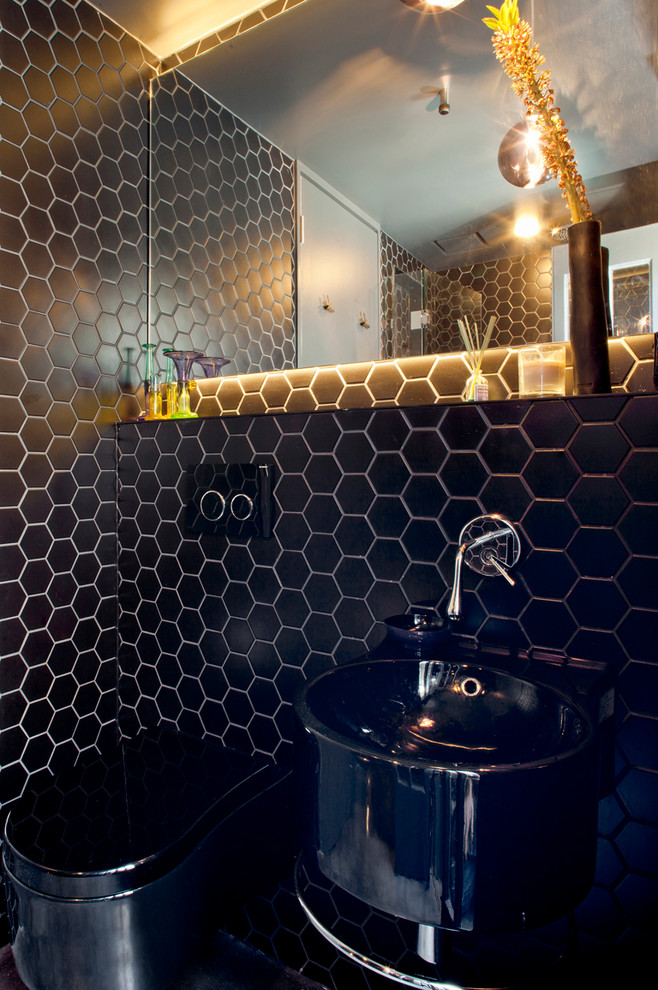 Photo of a small modern powder room in Sydney with a wall-mount toilet, black tile, mosaic tile, black walls and a wall-mount sink.