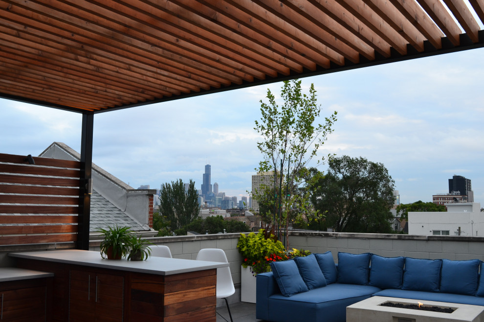 Mid-sized contemporary rooftop deck in Chicago with with fireplace and a pergola.
