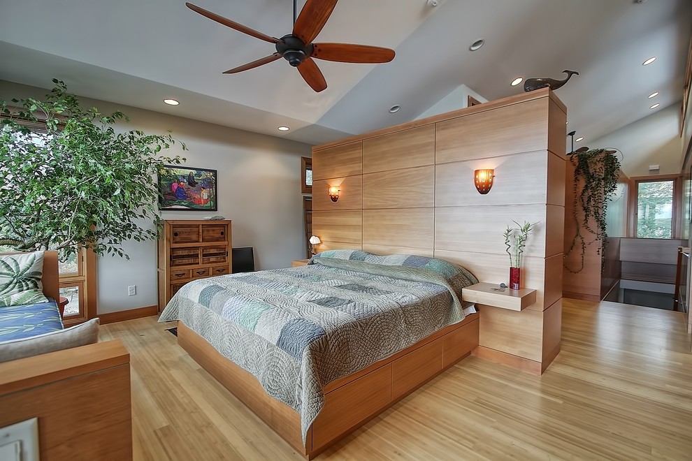 Photo of a contemporary bedroom in Minneapolis with white walls and light hardwood floors.