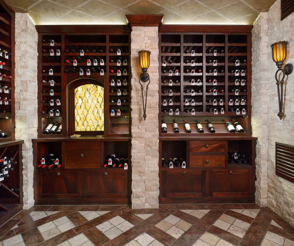 This is an example of an expansive traditional wine cellar in Kansas City with porcelain floors, display racks and beige floor.