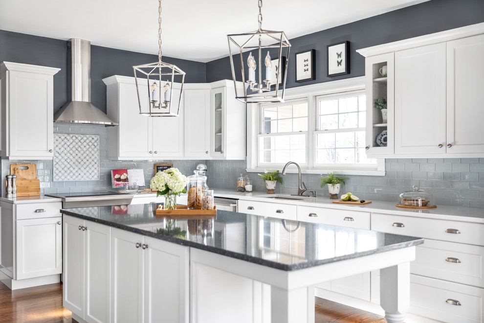 Inspiration for an expansive transitional l-shaped kitchen in Philadelphia with a single-bowl sink, white cabinets, quartzite benchtops, grey splashback, ceramic splashback, stainless steel appliances, dark hardwood floors, with island, brown floor, white benchtop and shaker cabinets.