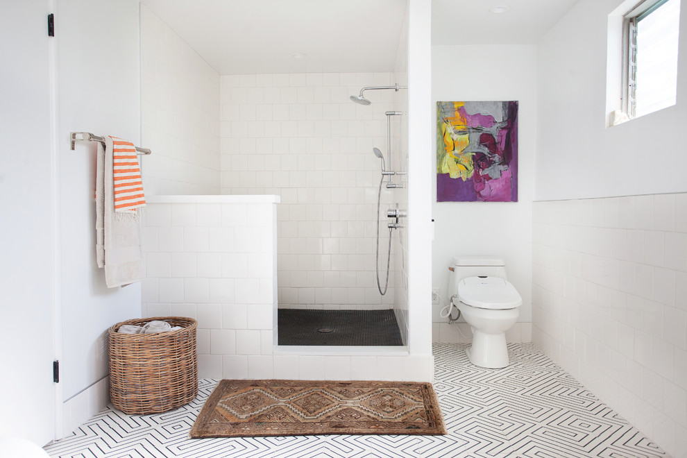 This is an example of a midcentury master bathroom in Los Angeles with a two-piece toilet, white tile, white walls, white floor and an open shower.