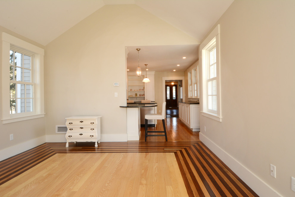 Design ideas for a large traditional family room in Boston with beige walls and light hardwood floors.