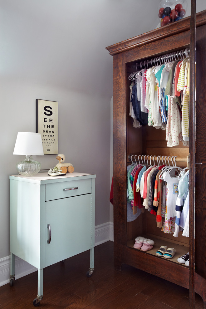 Photo of a transitional gender-neutral nursery in Toronto with grey walls and dark hardwood floors.