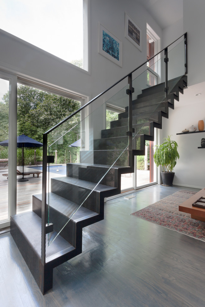 This is an example of a mid-sized contemporary metal straight staircase in New York with metal risers.