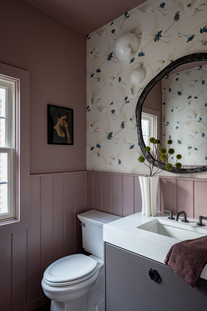 Inspiration for a transitional wainscoting and wallpaper powder room remodel in Boston with flat-panel cabinets, gray cabinets, multicolored walls, an undermount sink and white countertops