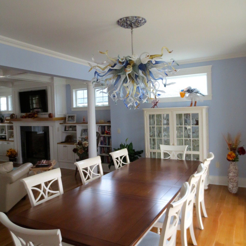 Design ideas for a large arts and crafts open plan dining in New York with blue walls and light hardwood floors.