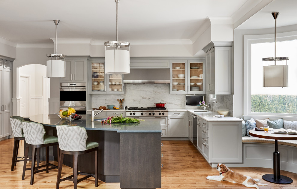 Inspiration for a huge transitional u-shaped eat-in kitchen remodel in New York with an undermount sink, recessed-panel cabinets, gray cabinets, quartz countertops, gray backsplash, marble backsplash, paneled appliances, an island and gray countertops