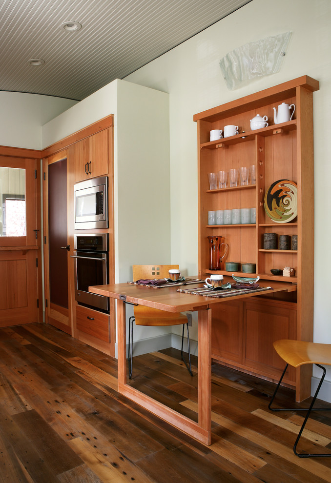 Contemporary eat-in kitchen in Los Angeles with flat-panel cabinets and medium wood cabinets.