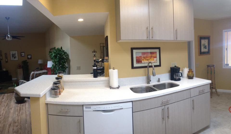 Inspiration for a galley porcelain tile eat-in kitchen remodel in Phoenix with an undermount sink, flat-panel cabinets, gray cabinets, quartz countertops and stainless steel appliances
