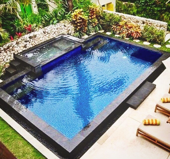 Photo of a mid-sized modern front yard rectangular aboveground pool with a pool house and tile.