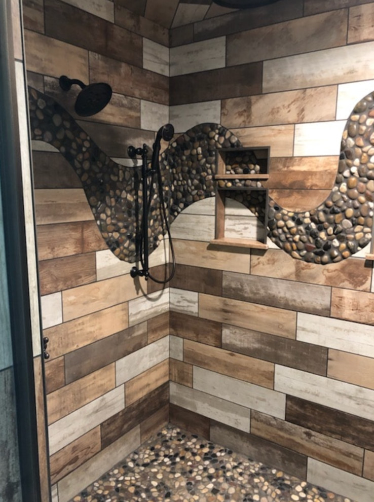 Mid-sized traditional master bathroom in Other with a corner shower, a two-piece toilet, beige tile, brown tile, gray tile, porcelain tile, multi-coloured walls, pebble tile floors, multi-coloured floor and a hinged shower door.