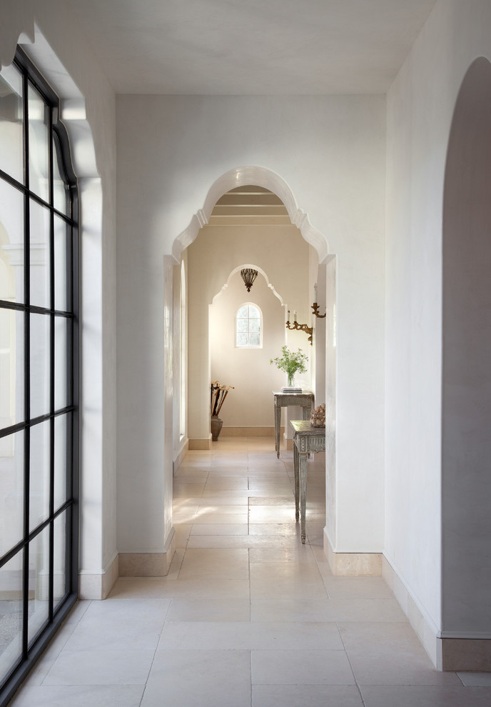 Inspiration for a mediterranean hallway in Austin with white walls and white floor.