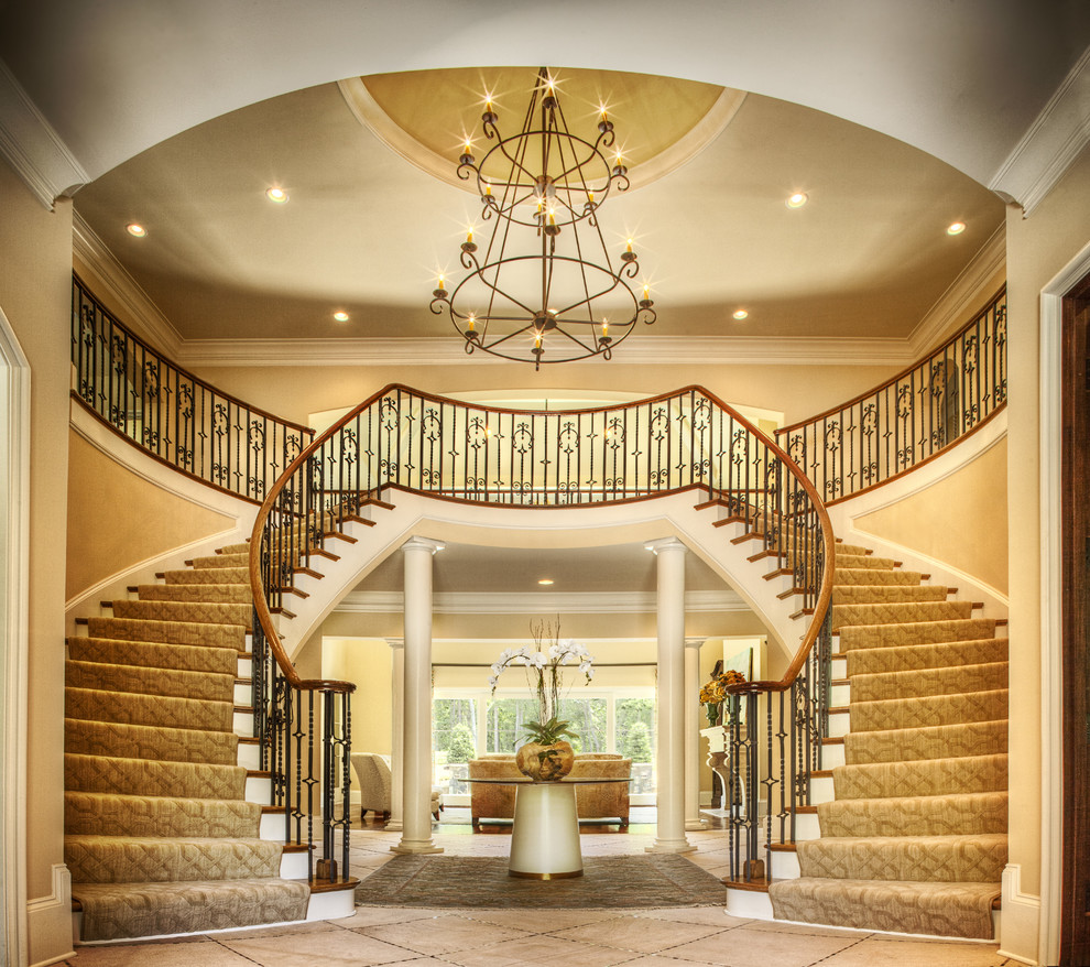 Large traditional wood u-shaped staircase in Charlotte with painted wood risers.