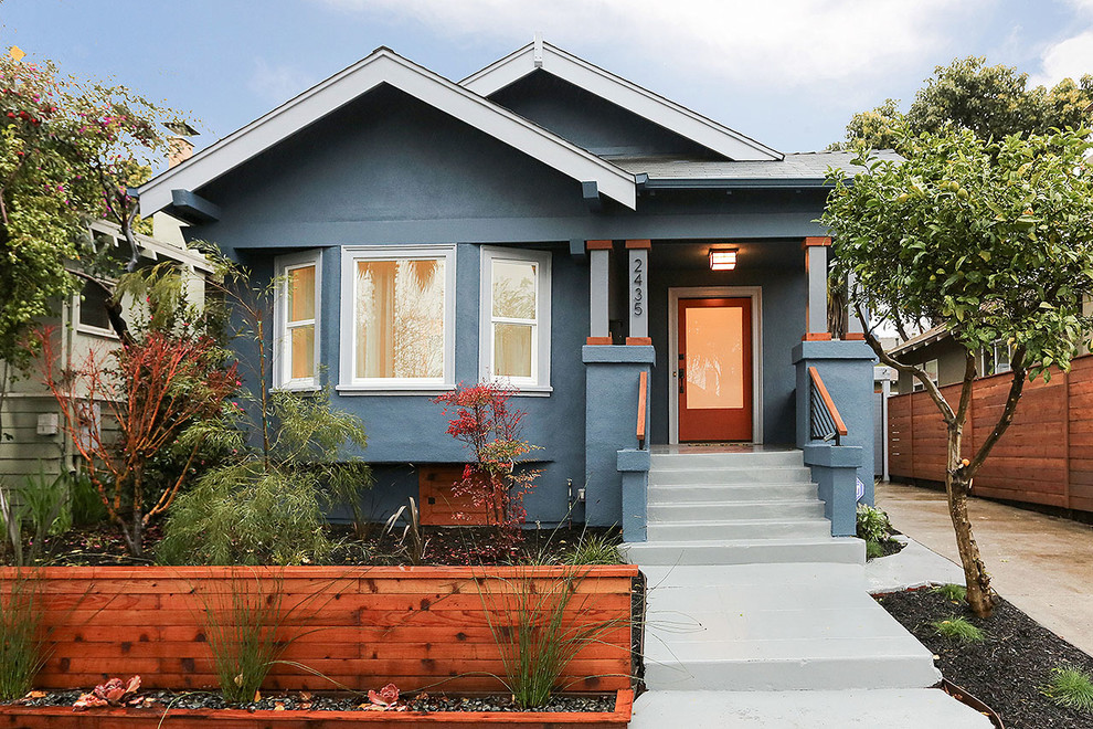 Design ideas for an arts and crafts one-storey stucco blue exterior in San Francisco with a gable roof.