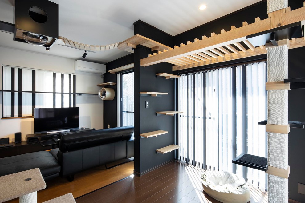 Esempio di un soggiorno minimalista di medie dimensioni e stile loft con pareti nere e TV autoportante