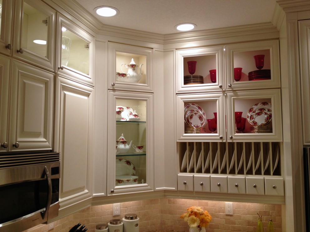 Large transitional u-shaped ceramic tile and beige floor open concept kitchen photo in Miami with a single-bowl sink, raised-panel cabinets, white cabinets, granite countertops, multicolored backsplash, stone tile backsplash, stainless steel appliances and an island