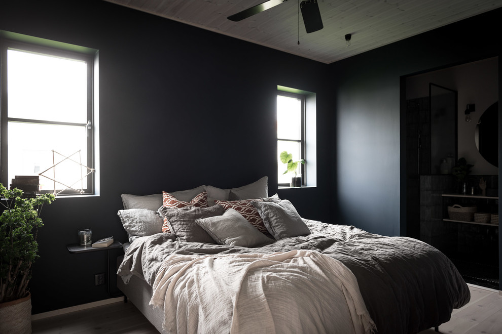 Scandinavian bedroom with black walls.