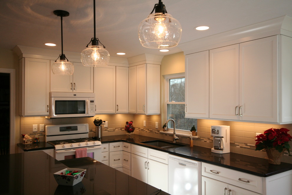 Eat-in kitchen - mid-sized transitional l-shaped medium tone wood floor eat-in kitchen idea with an undermount sink, recessed-panel cabinets, white cabinets, quartz countertops, beige backsplash, ceramic backsplash, white appliances and an island