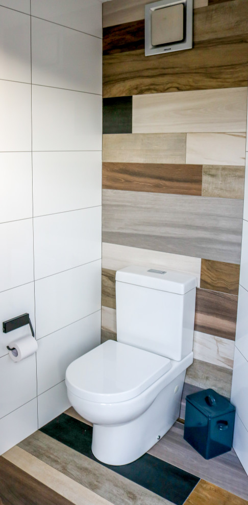 Inspiration for a small contemporary powder room in Sydney with a one-piece toilet, white tile, ceramic tile and porcelain floors.