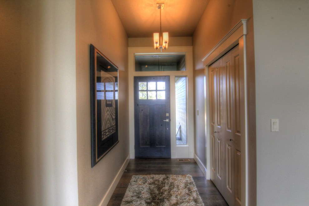 Foyer - mid-sized transitional dark wood floor and brown floor foyer idea in Seattle with beige walls and a dark wood front door